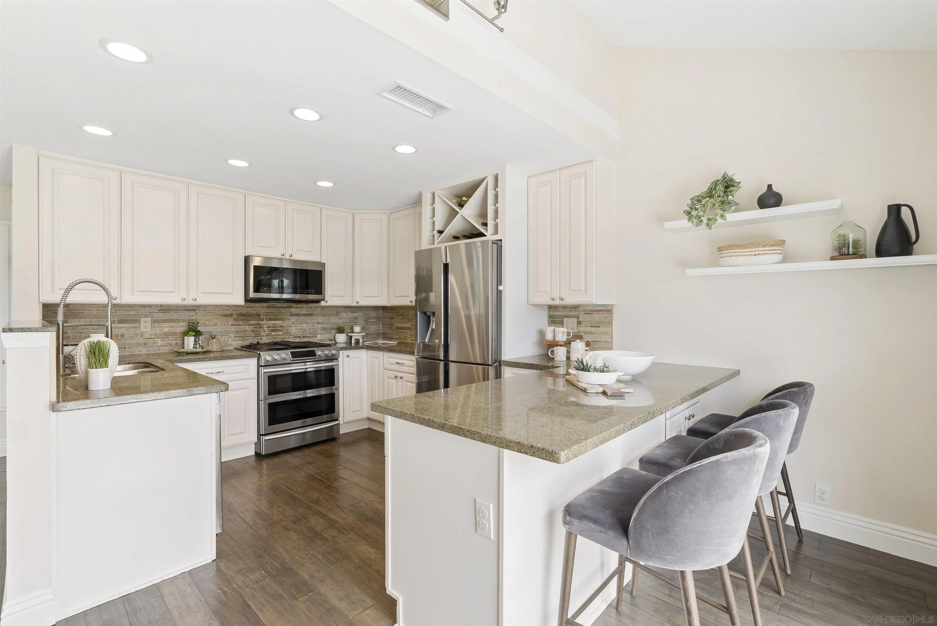 2691 Coventry Road Carlsbad, CA 92010 - Photo 6 of 19 a kitchen with kitchen island granite countertop a sink stove and refrigerator
