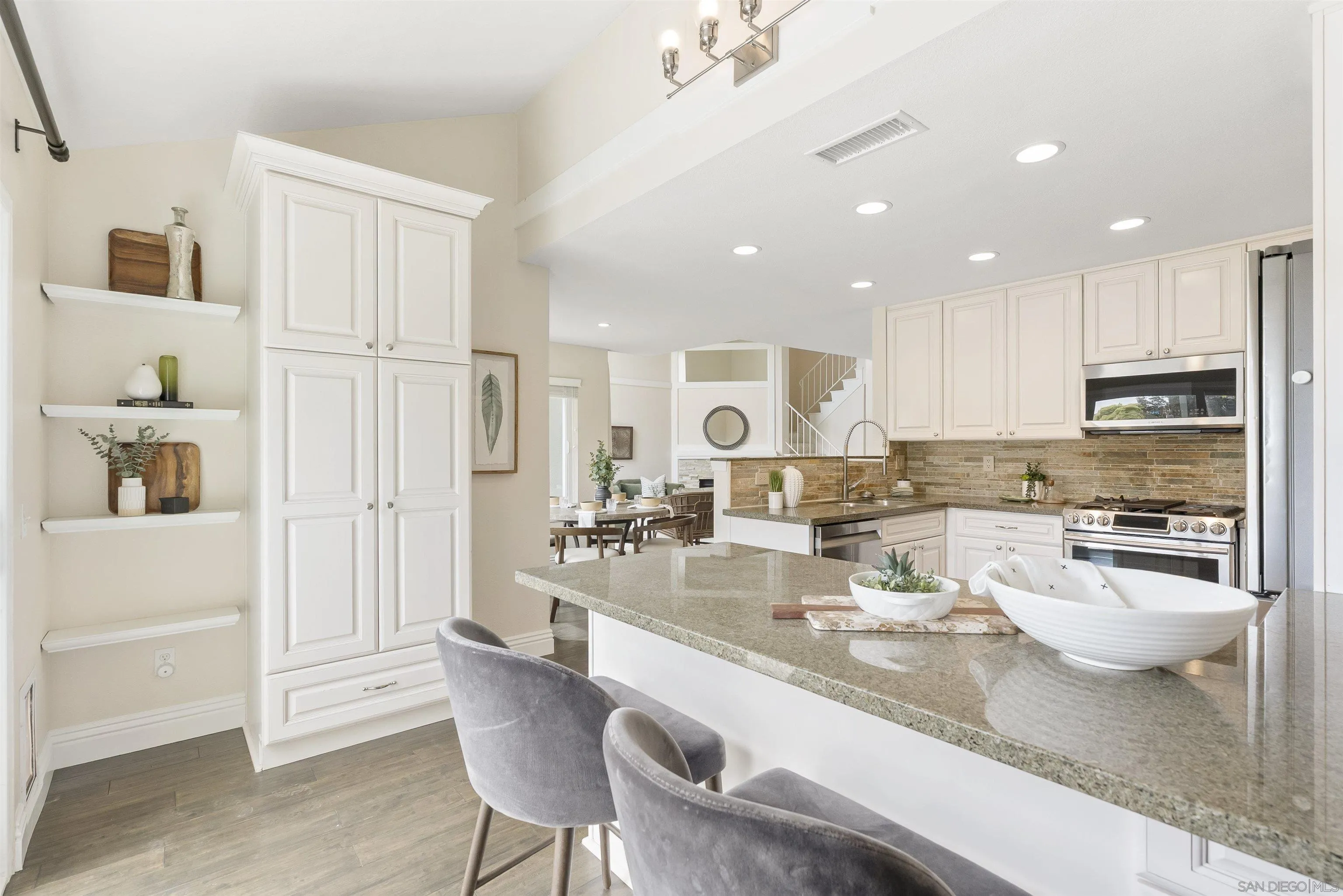 2691 Coventry Road Carlsbad, CA 92010 - Photo 7 of 19 a kitchen with a refrigerator and white cabinets