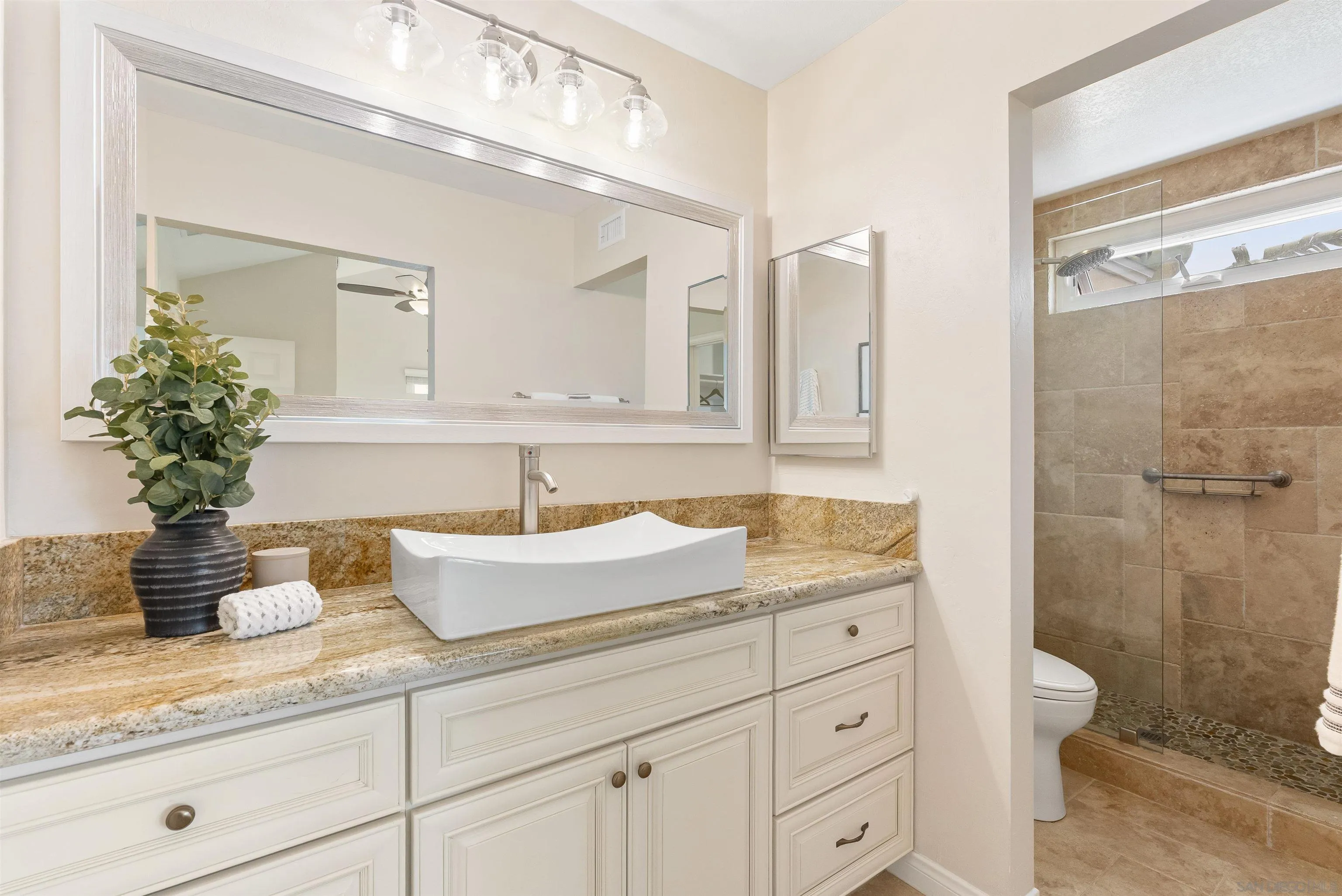 2691 Coventry Road Carlsbad, CA 92010 - Photo 9 of 19 a bathroom with a granite countertop sink a toilet and a mirror