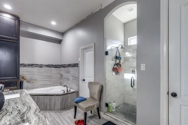 a bathroom with a granite countertop sink a toilet and shower
