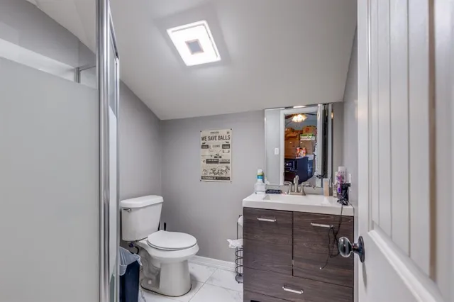 a bathroom with a sink toilet and mirror