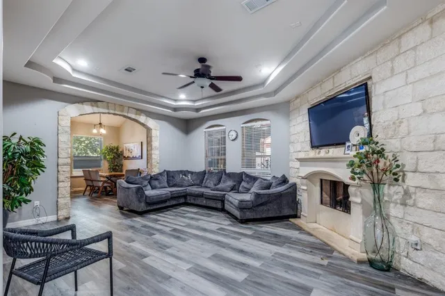a living room with furniture a fireplace and a potted plant