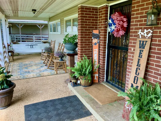 a view of house with a potted plant ana a small yard