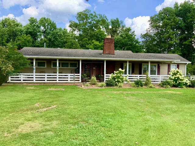 a front view of a house with a yard table and chairs