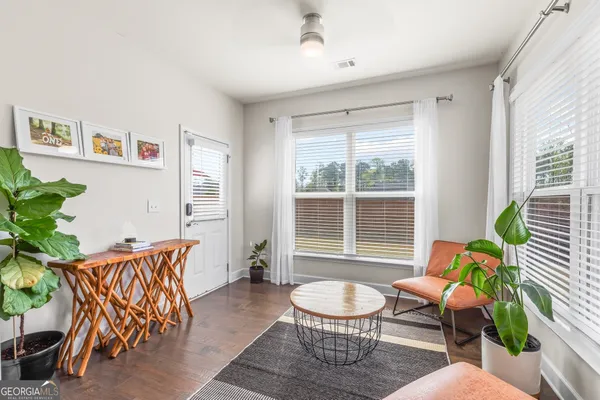 a kitchen with a sink a stove and wooden floor
