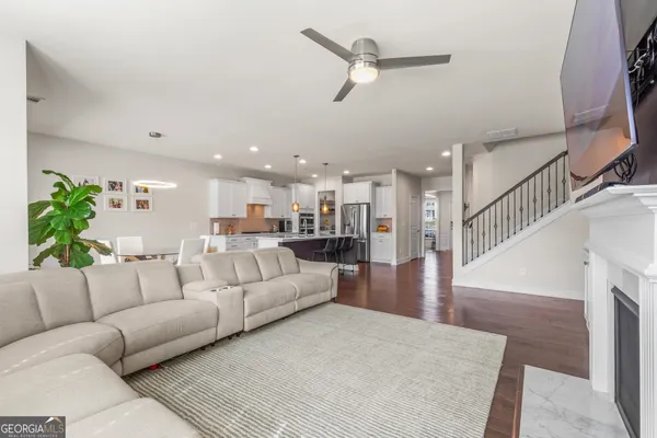a bathroom with a granite countertop sink a toilet and a mirror