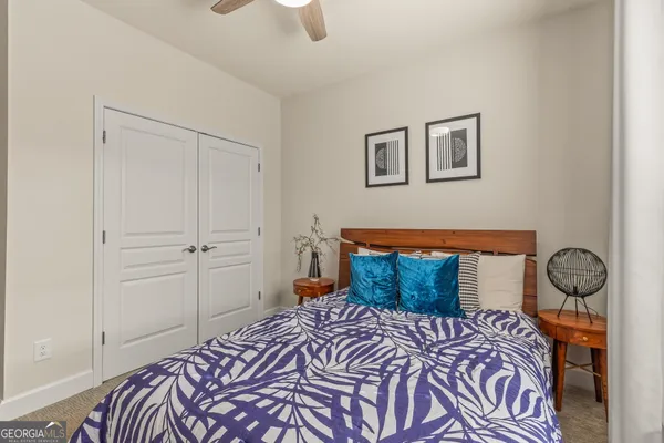 a bedroom with a bed a chandelier and a window