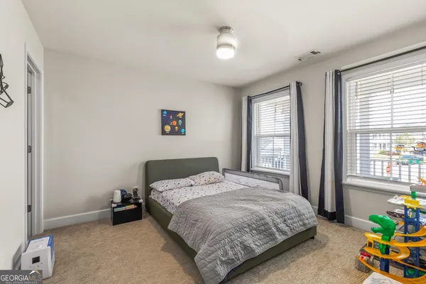 a bathroom with a sink a toilet and shower curtain