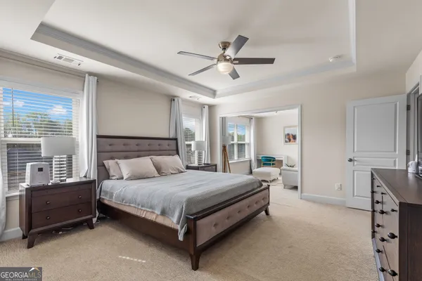 a view of a house with pool and sitting area