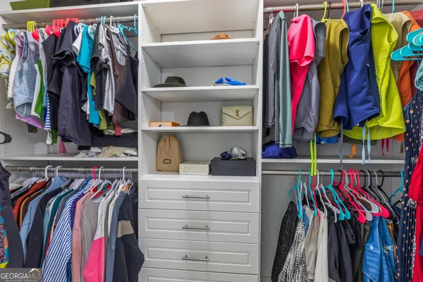 a view of a house with a yard and potted plants