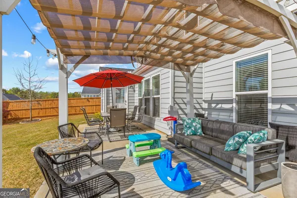 a swimming pool with outdoor seating and yard