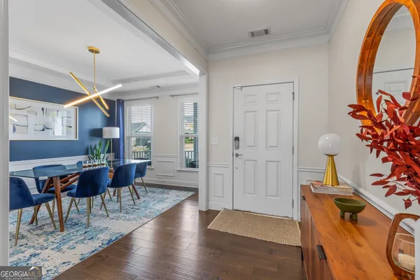 a dining room with furniture and wooden floor