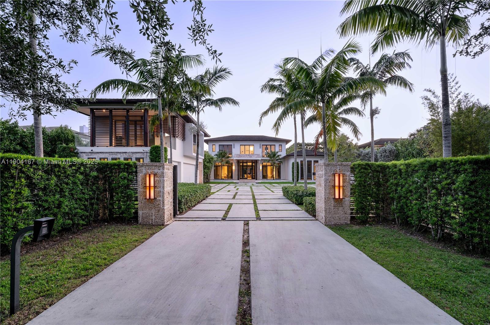 9000 Southwest 63rd Court Pinecrest, FL 33156 - Photo 11 of 36 a view of a white house with a yard and potted plants