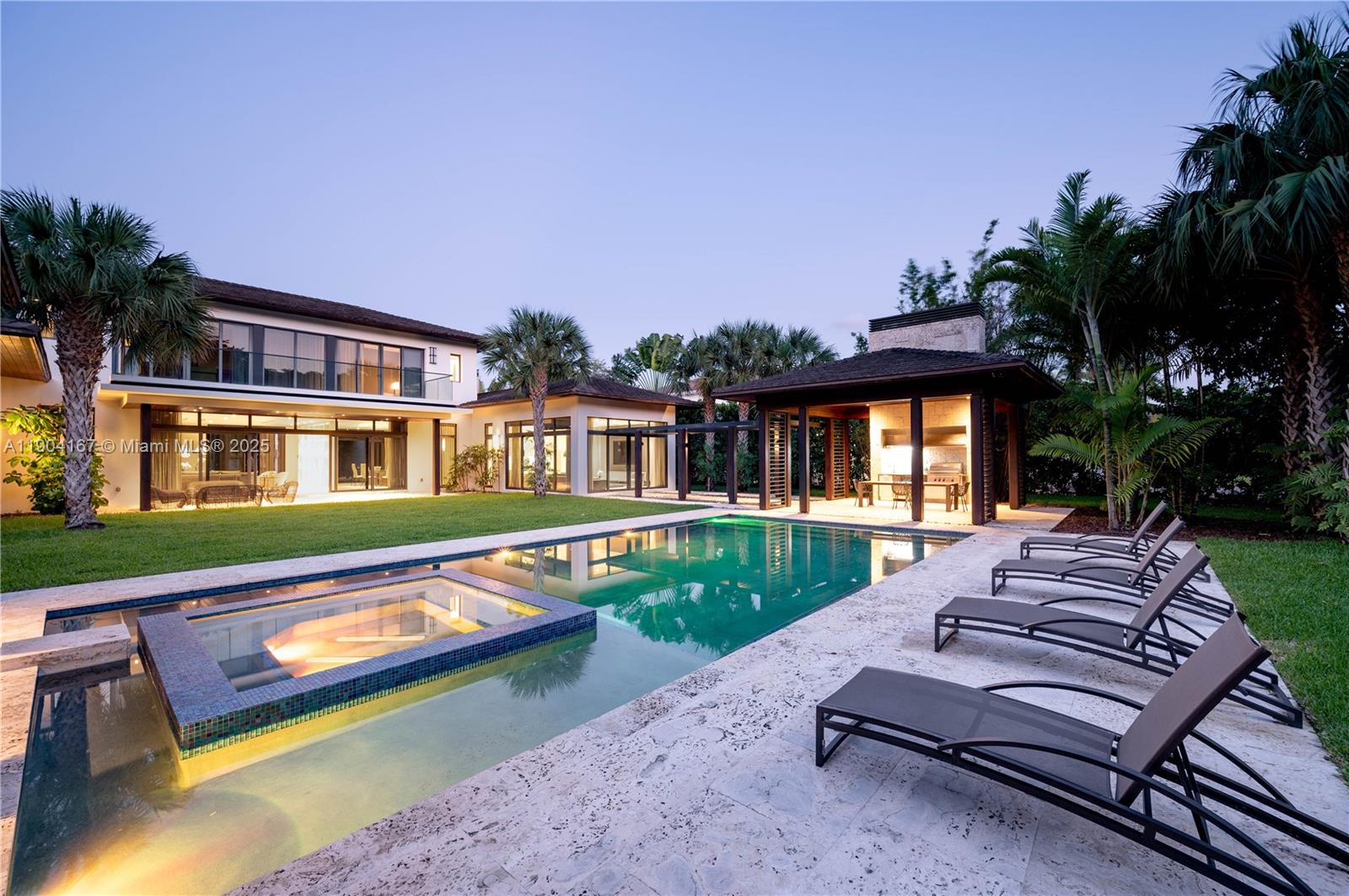 9000 Southwest 63rd Court Pinecrest, FL 33156 - Photo 15 of 36 a front view of a house with a yard table and chairs