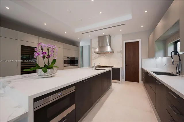 a kitchen with kitchen island granite countertop a sink and stove