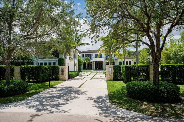 a view of a park with plants and large trees