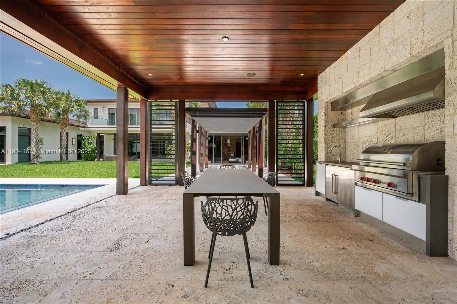 9000 Southwest 63rd Court Pinecrest, FL 33156 - Photo 23 of 36 a view of a chairs and table in the patio