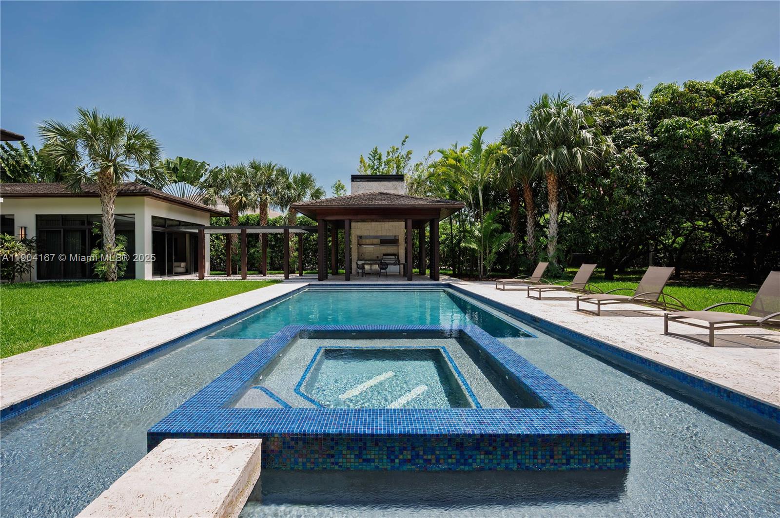 9000 Southwest 63rd Court Pinecrest, FL 33156 - Photo 27 of 36 a view of swimming pool with chairs and yard