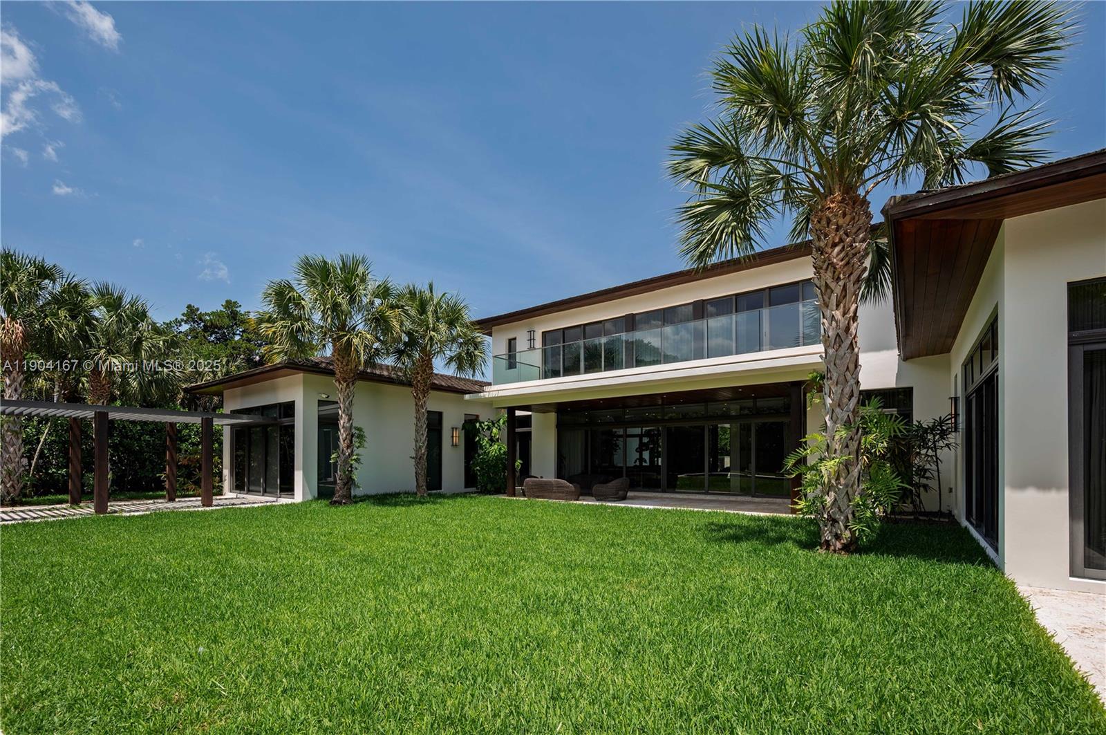 9000 Southwest 63rd Court Pinecrest, FL 33156 - Photo 28 of 36 a view of house with a yard and front door