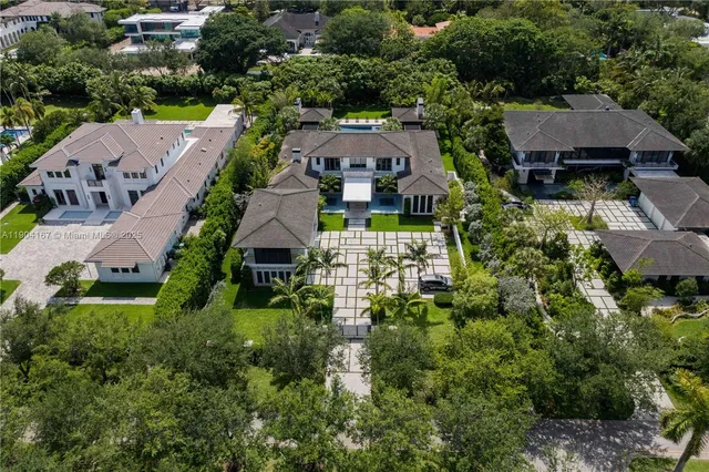 an aerial view of multiple houses with yard