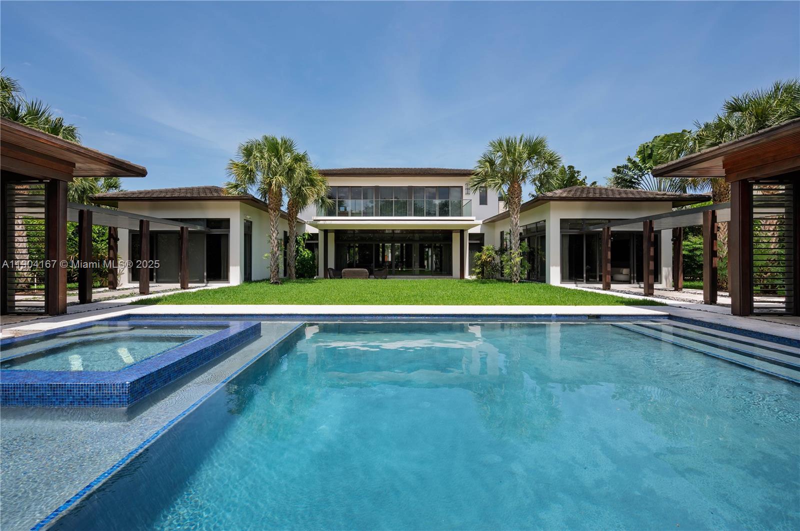 9000 Southwest 63rd Court Pinecrest, FL 33156 - Photo 10 of 36 a view of an house with swimming pool and a large tree