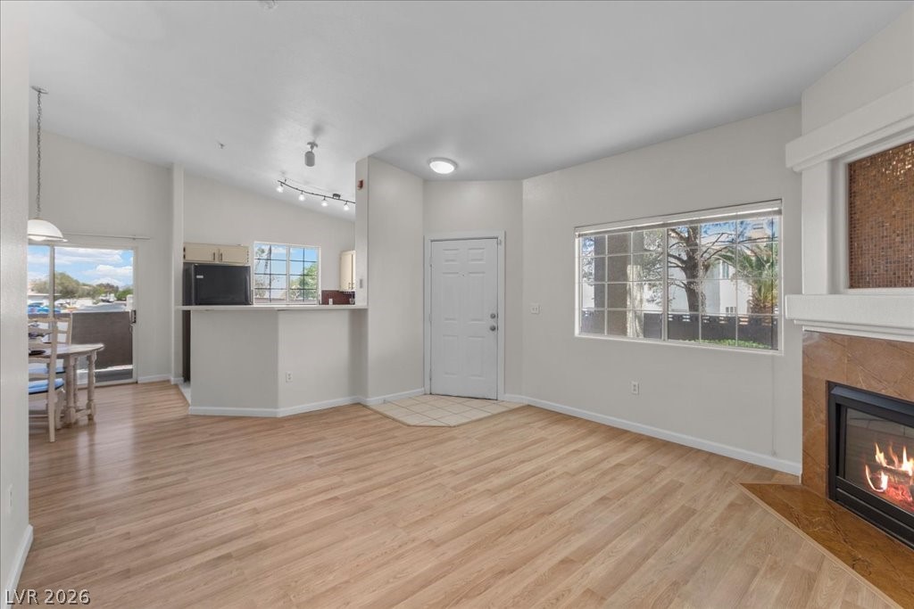 1881 West Alexander Road, Unit 1037 North Las Vegas, NV 89032 - Photo 11 of 31 Blonde wood flooring throughout creates a warm, unified space with a cozy fireplace.