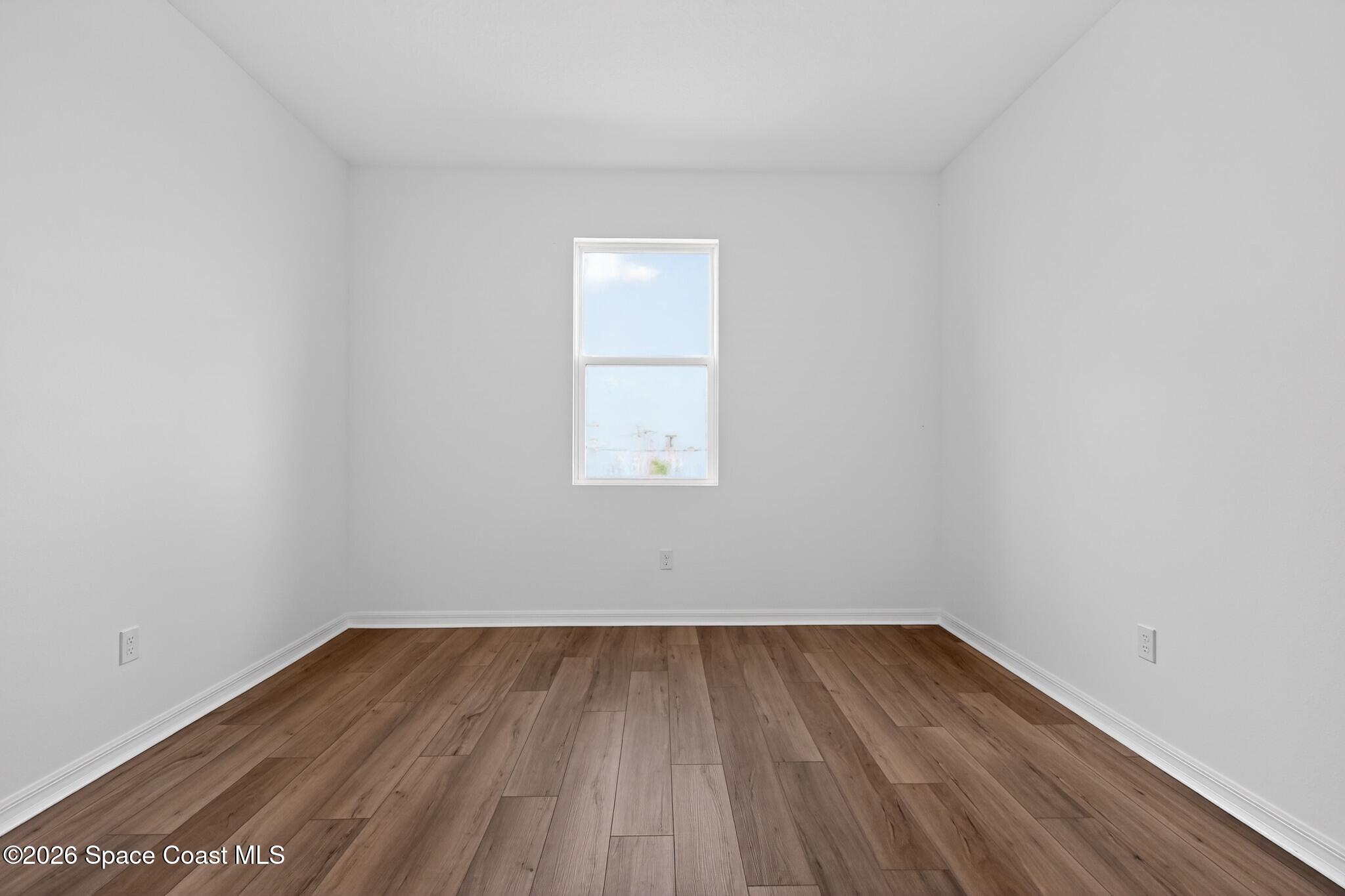 4372 Dockyard Drive Rockledge, FL 32955 - Photo 11 of 24 a view of a room that has wooden floor and white walls