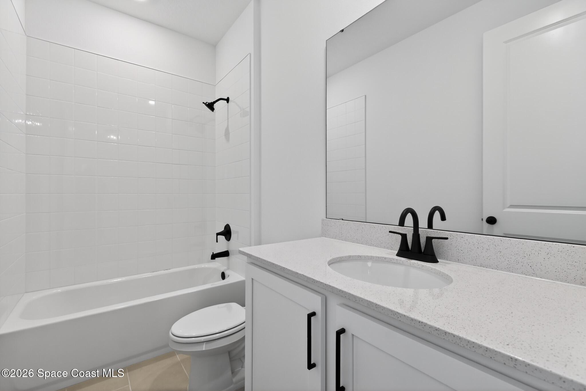 4372 Dockyard Drive Rockledge, FL 32955 - Photo 13 of 24 a bathroom with a sink a toilet and a bathtub