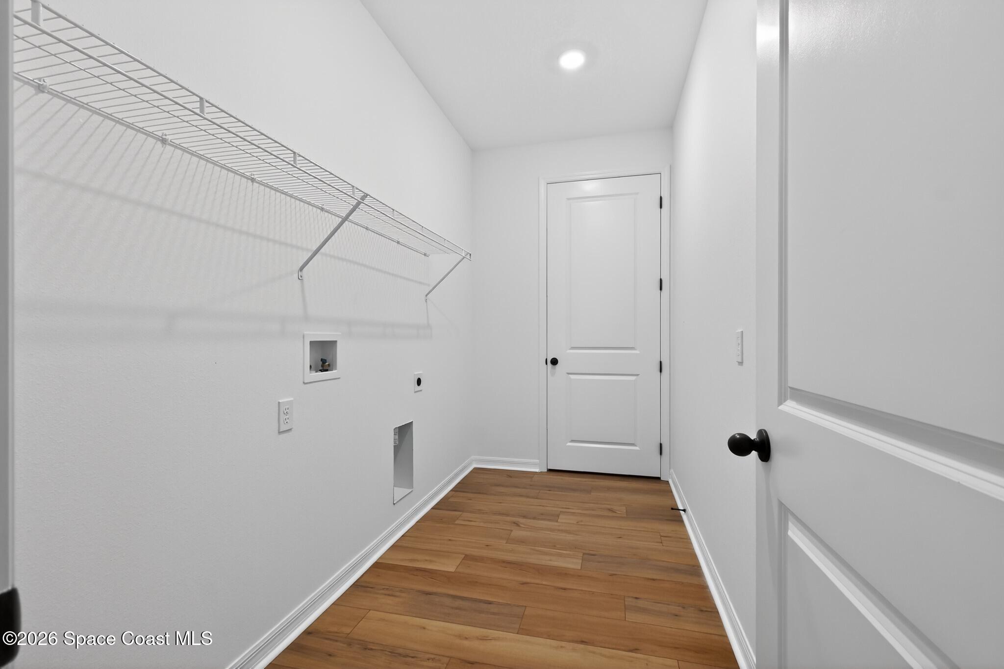 4372 Dockyard Drive Rockledge, FL 32955 - Photo 21 of 24 a view of a hallway with wooden floor and a ceiling fan