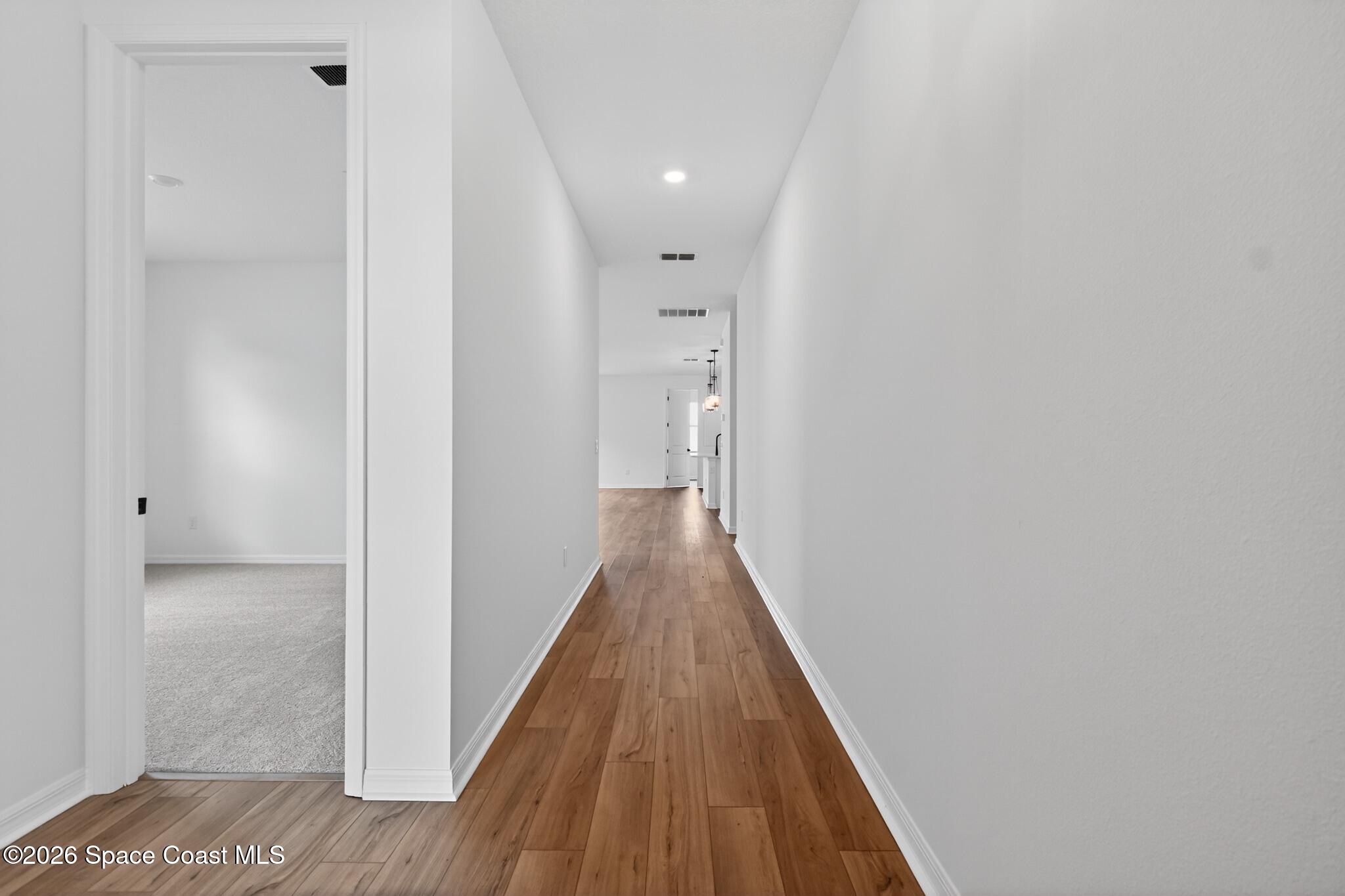 4372 Dockyard Drive Rockledge, FL 32955 - Photo 3 of 24 a view of a hallway with wooden floor