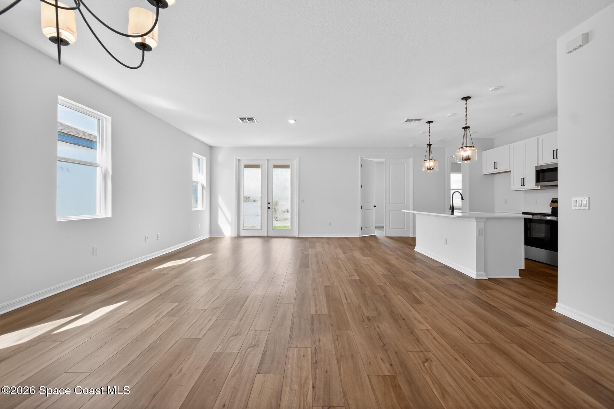 4372 Dockyard Drive Rockledge, FL 32955 - Photo 4 of 24 a view of a kitchen with wooden floor and windows