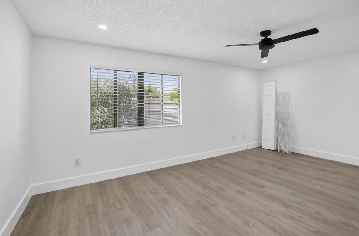 373 Northwest 94th Terrace Plantation, FL 33324 - Photo 1 of 10 wooden floor in an empty room with a window
