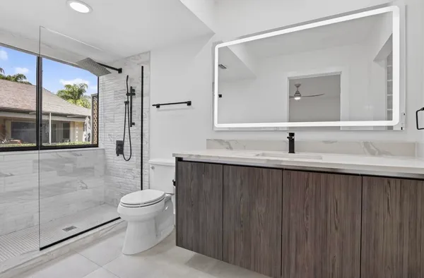 a bathroom with a sink toilet and shower