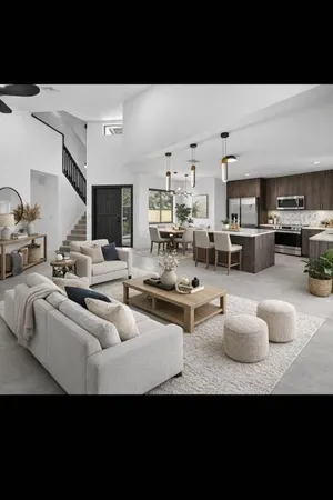 a living room with furniture a rug and kitchen view