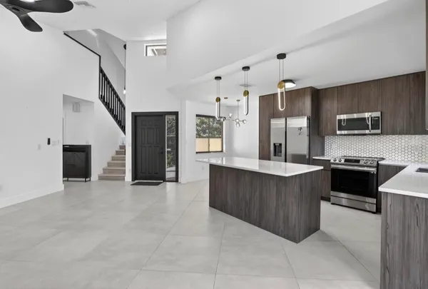 a large kitchen with cabinets and stainless steel appliances