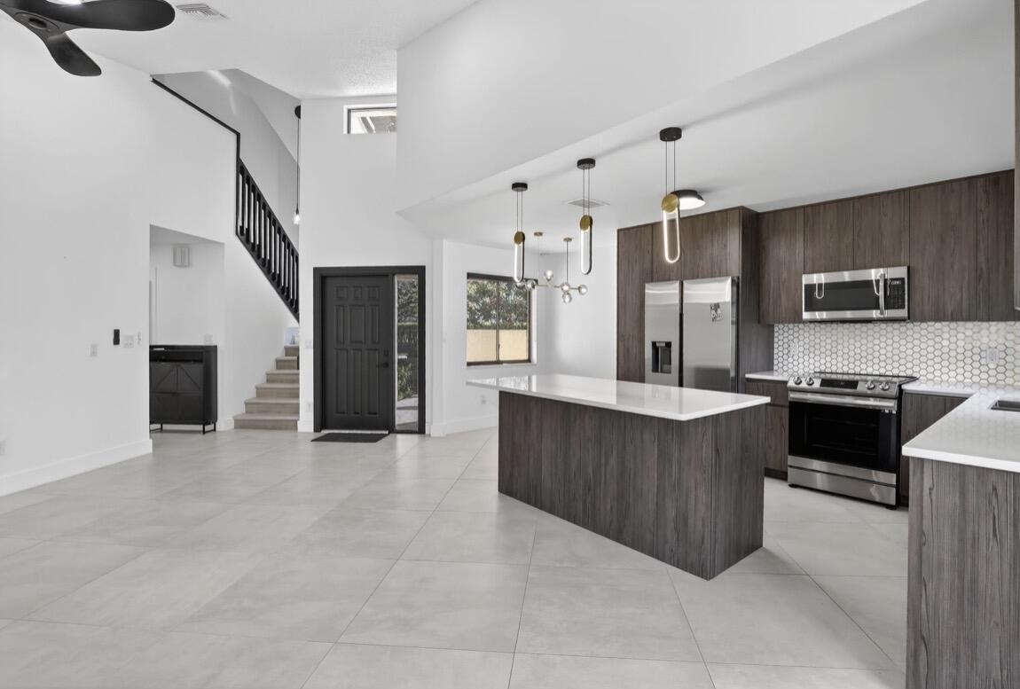 373 Northwest 94th Terrace Plantation, FL 33324 - Photo 9 of 10 a large kitchen with cabinets and stainless steel appliances