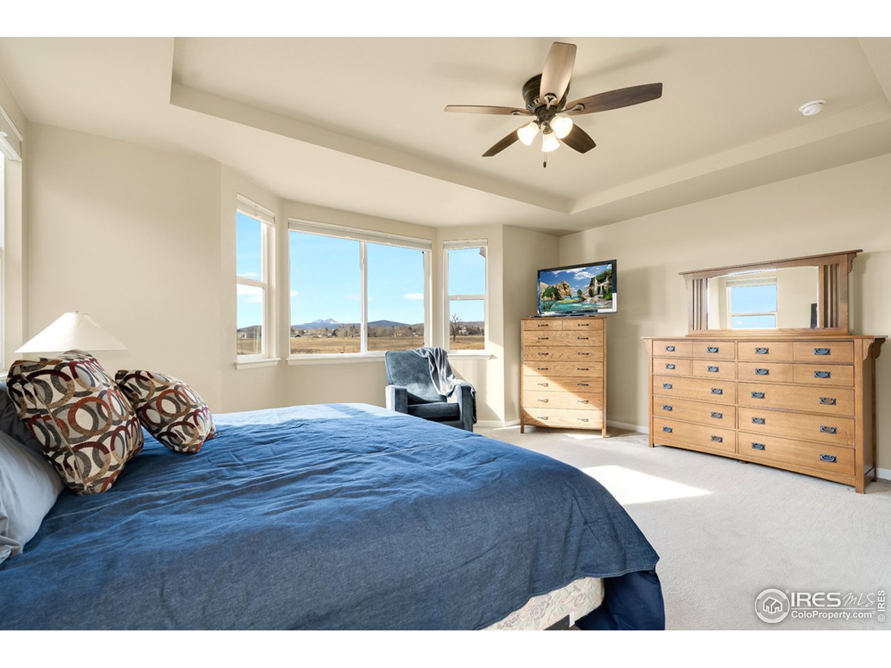 709 Snowy Plain Road Fort Collins, CO 80525 - Photo 15 of 40 Primary bedroom with French doors, tray ceiling, bay window, walk-in closet, and en suite 5-piece bathroom