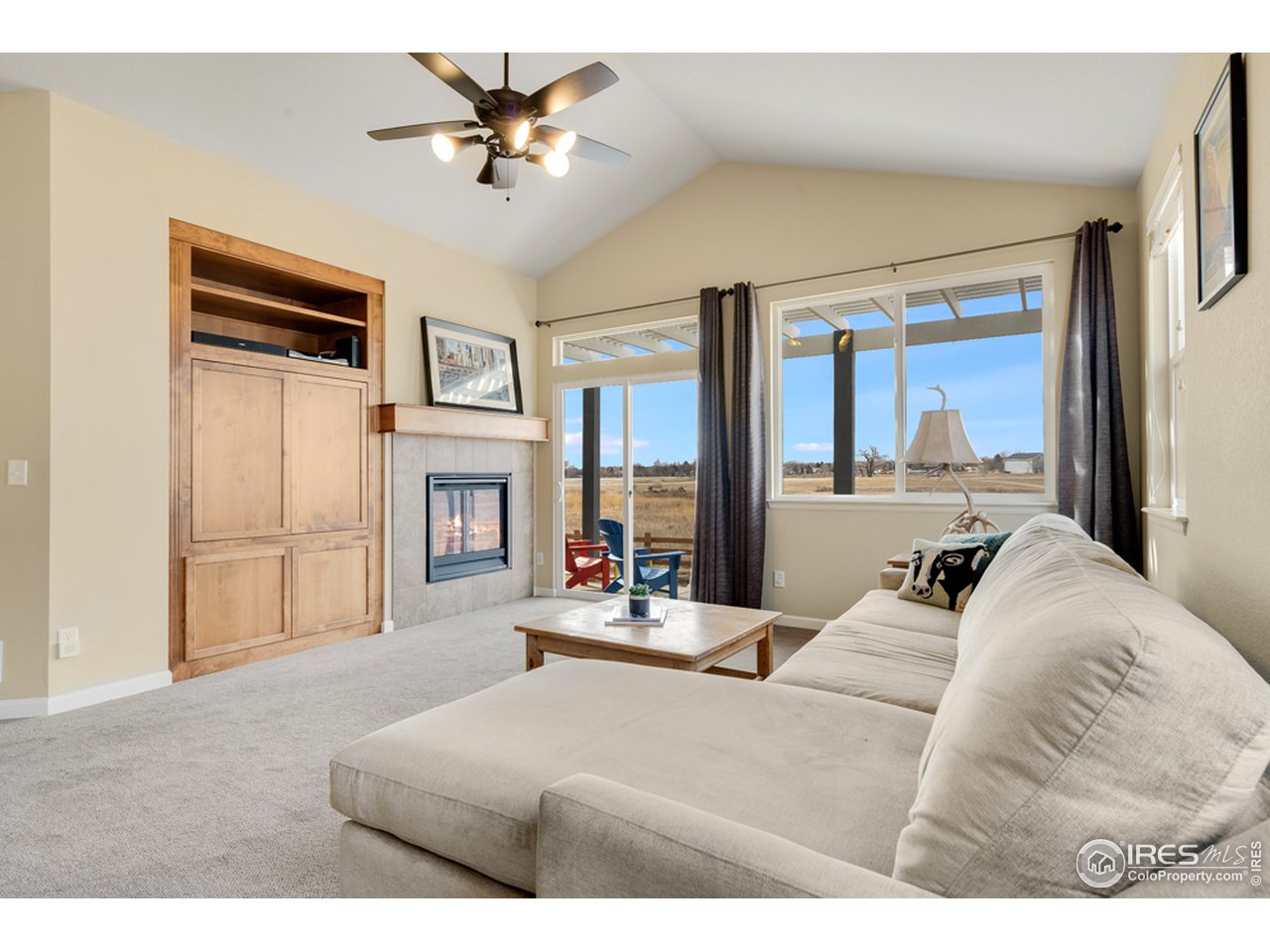 709 Snowy Plain Road Fort Collins, CO 80525 - Photo 6 of 40 The great room has vaulted ceilings, cozy fireplace and walk out to the back patio overlooking Pelican Marsh Natural Area.