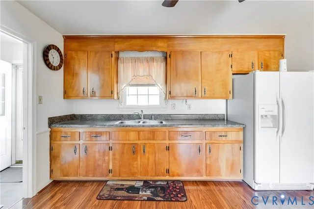 a kitchen with stainless steel appliances granite countertop a refrigerator and a stove