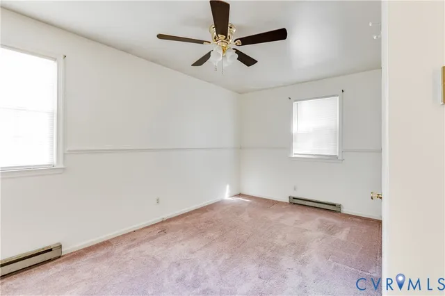 an empty room with a ceiling fan