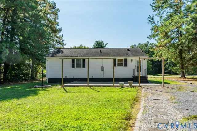 a backyard of a house with table and chairs