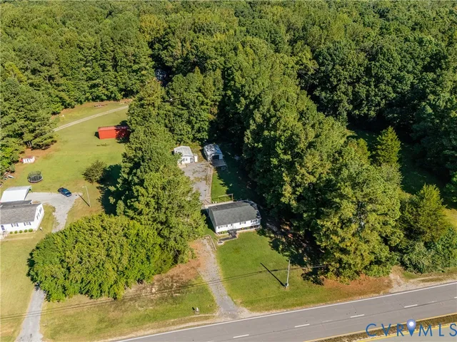an aerial view of a houses with a yard