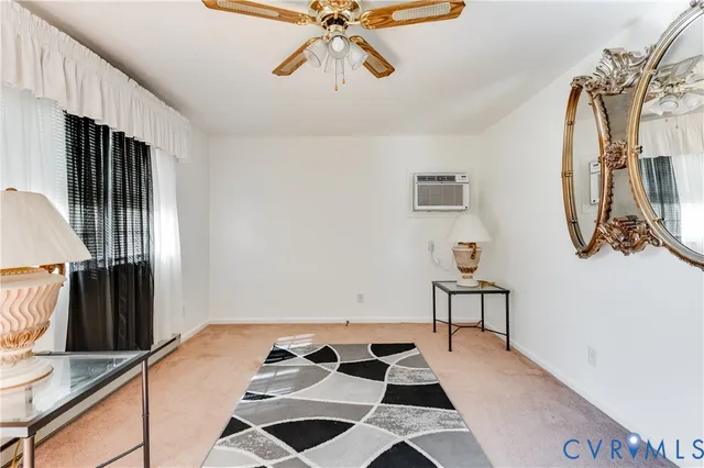 a view of a bedroom with wooden floor and a chandelier fan