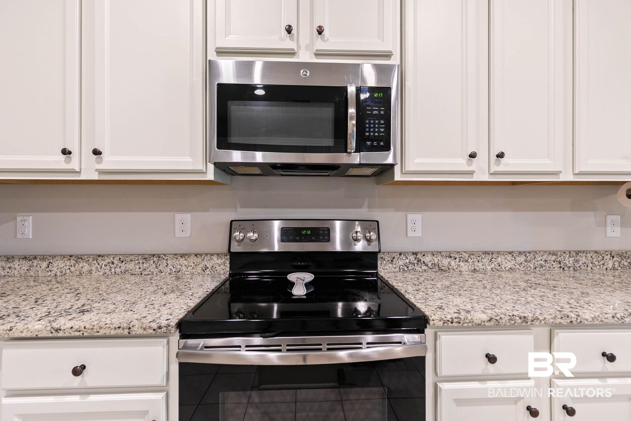 12750 B Jenkins Pit Road Daphne, AL 36527 - Photo 26 of 89 Kitchen with stainless steel appliances, light stone counters, and white cabinets