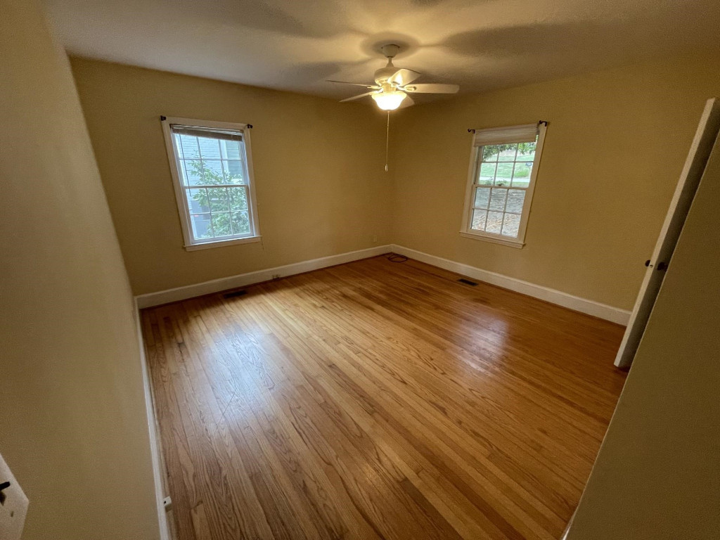 200 East Drewry Lane Raleigh, NC 27609 - Photo 14 of 22 a view of empty room with window and wooden floor