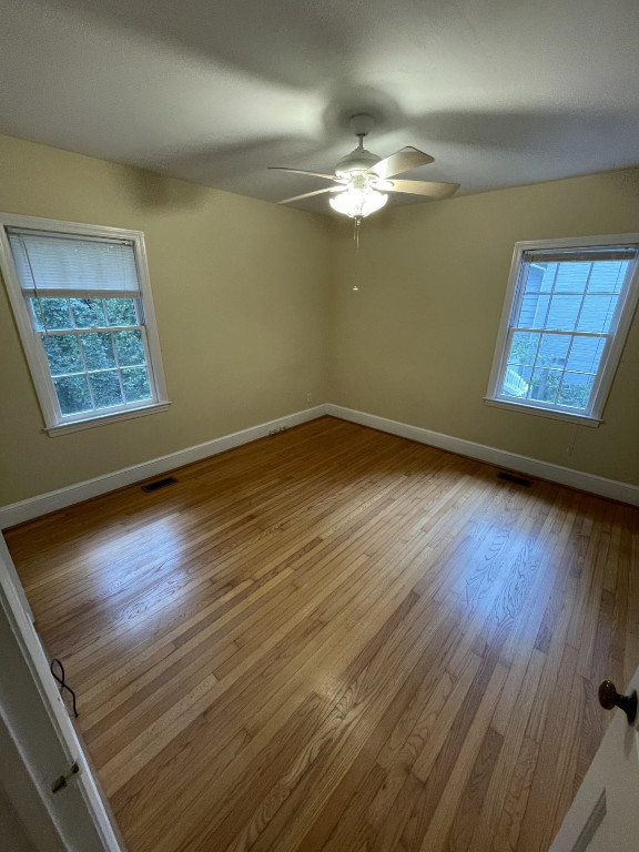 200 East Drewry Lane Raleigh, NC 27609 - Photo 16 of 22 a view of an empty room with wooden floor and a window