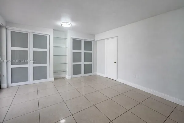 a view of an empty room with empty shelves