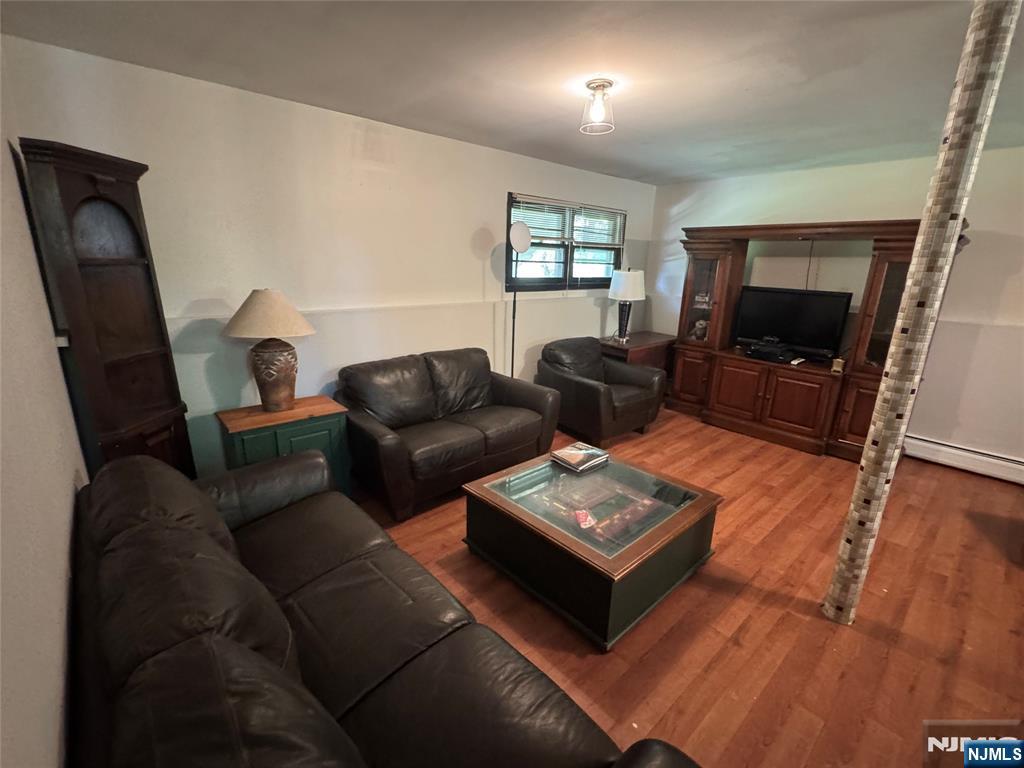 55 Maryann Road Oak Ridge, NJ 07438 - Photo 19 of 20 a living room with furniture and a flat screen tv