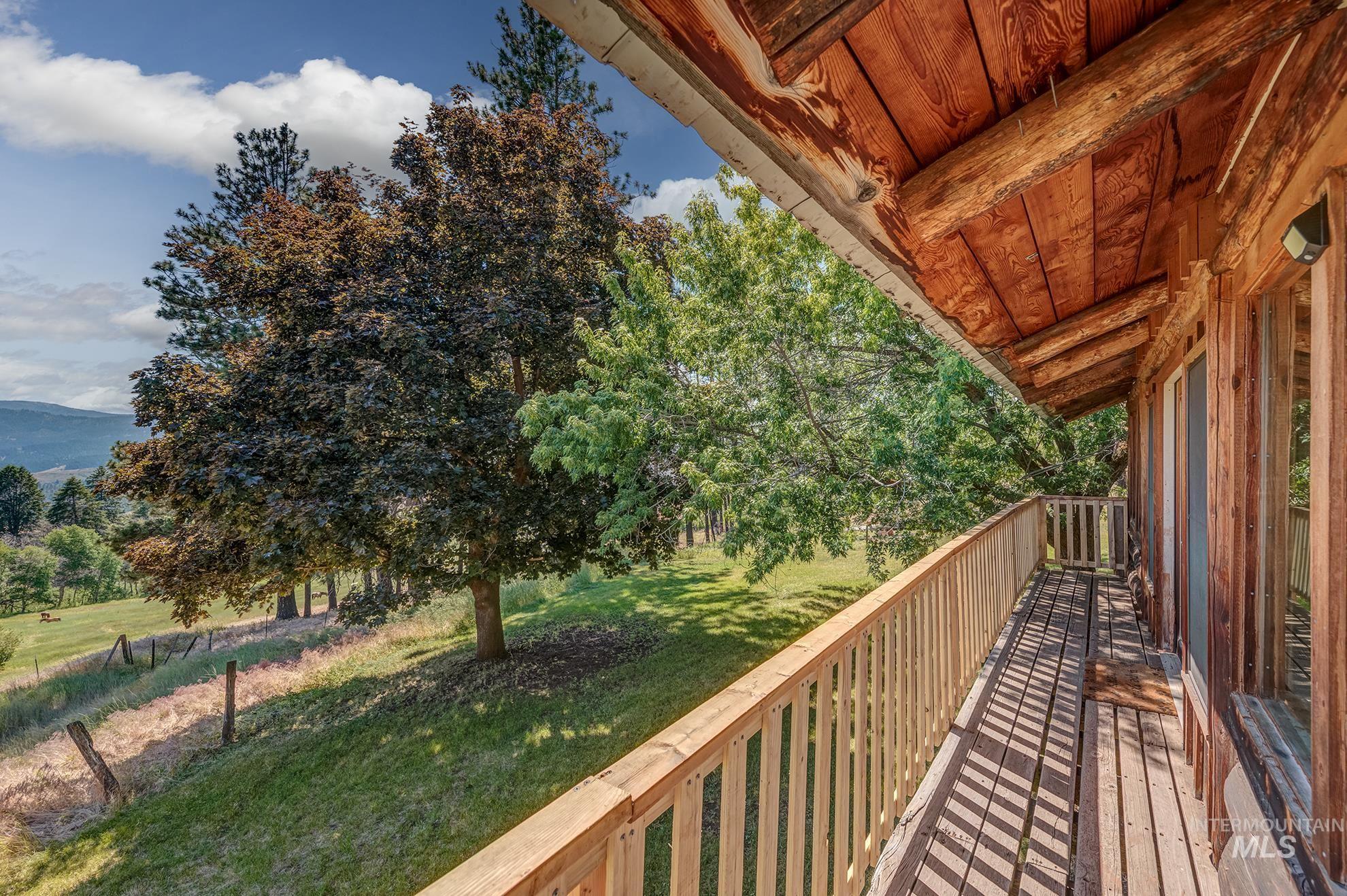 2150 Seid Creek Road Cambridge, ID 83610 - Photo 14 of 50 Wood-plank balcony with natural wood railing, featuring an exposed beam ceiling