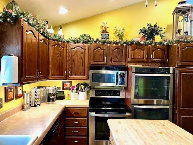 a kitchen with a sink and a stove top oven
